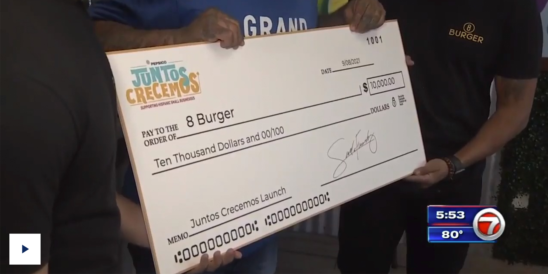 Screen of a TV program showing a big cheque.